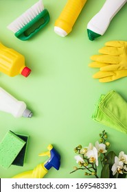 Household Cleaning Eco Spring Background. Cleaning Products Flat Lay, Chemical Detergent Bottles And Fresh Blossoms On Green Color Background,