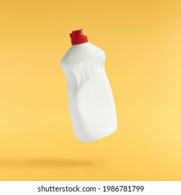 Household Cleaning Product. A Plastic Bottle Falling In The Air Isolated On Yellow Background. Product Mockup For Your Brand