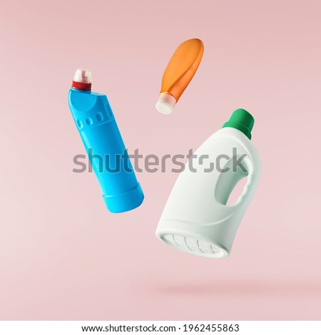 Household cleaning product. A plastic bottle falling in the air isolated on pink background. Product mockup for your brand