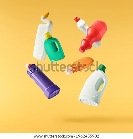Household cleaning product. A plastic bottle falling in the air isolated on yellow background. Product mockup for your brand