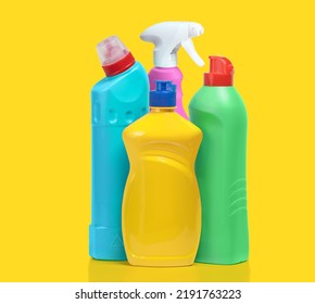 Household Cleaning Products In Plastic Bottles Isolated On A Yellow Background. Colorful Plastic Bottles Product Mockup.