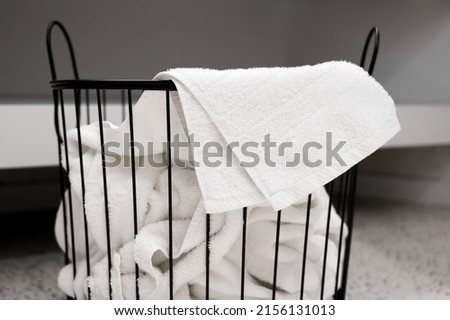 Household concept. A laundry basket full of dirty towels and clothes