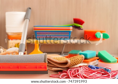 Household items. Household goods are collected in a heap. An ironing board, a clothesline, clothespins, toilet paper, plastic boxes, a brush for glasses, sponges for utensils are household utensils.