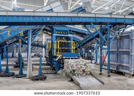 Household waste sorting and recycling plant. Press for pressing plastic bottles.