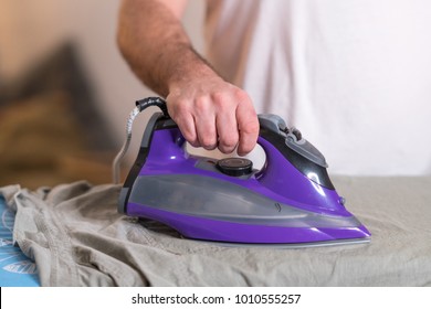 Househusband, Stay-at-home Dad Ironing Clothes. Cropped Image