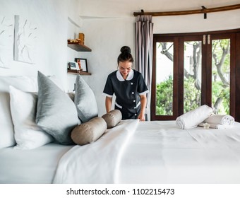 Housekeeper cleaning a hotel room - Shutterstock ID 1102215473
