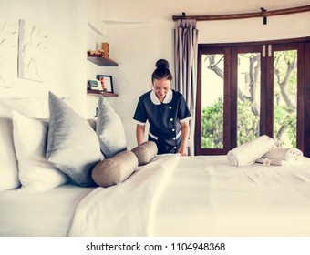 Housekeeper cleaning a hotel room - Shutterstock ID 1104948368