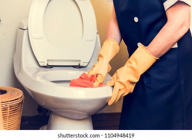 Housekeeper Cleaning A Hotel Room