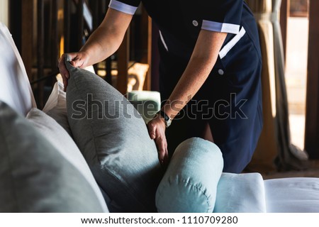 Housekeeper cleaning a hotel room