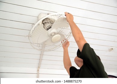 The Housekeeper Is Installing The Ceiling Fan After Being Cleaned. 