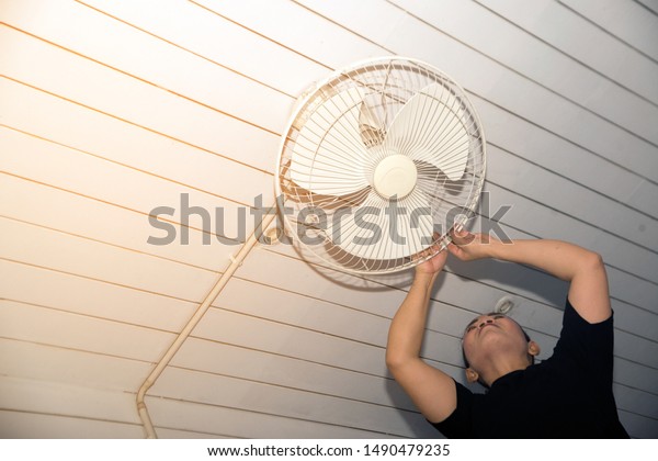 Housekeeper Installing Ceiling Fan After Being Stock Photo