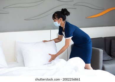 Housekeeper Or Maid Cleaning Hotel Room. Asian Woman Worker Working In Hotel And Resort. People Wearing Protective Face Mask Prevent Covid-19 Virus 