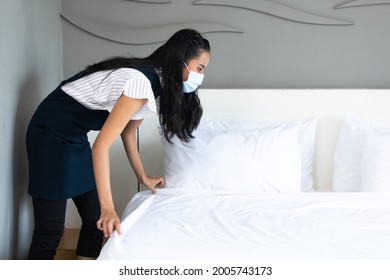 Housekeeper Or Maid Cleaning Hotel Room. Asian Woman Worker Working In Hotel And Resort. People Wearing Protective Face Mask Prevent Covid-19 Virus 