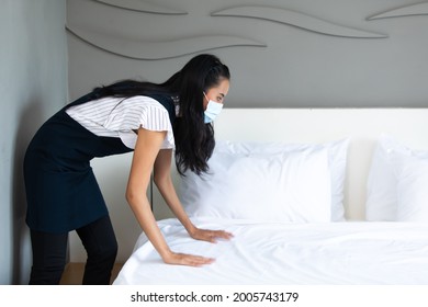 Housekeeper Or Maid Cleaning Hotel Room. Asian Woman Worker Working In Hotel And Resort. People Wearing Protective Face Mask Prevent Covid-19 Virus 