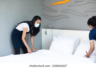 Housekeeper Or Maid Cleaning Hotel Room. Asian Woman Worker Working In Hotel And Resort. People Wearing Protective Face Mask Prevent Covid-19 Virus 