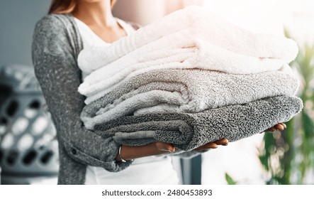 Housekeeping, hands of woman and towels at house for hygiene, fabric and organizing at home. Cleansing laundry, folded cotton and person at laundromat for spring clean, sanitary and textile in stack - Powered by Shutterstock