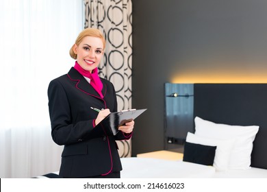 Housekeeping Manager Or Assistant Controlling Hotel Room Or Suit With Checklist On Tidiness 