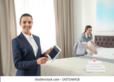 Housekeeping manager with tablet checking maid work in hotel room. Space for text - Shutterstock ID 1437146918