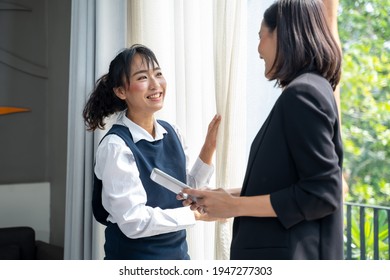 Housekeeping Manager Working On Digital Tablet And Controlling The Work Of Staff In The Hotel Room Before Guest's Arrival.