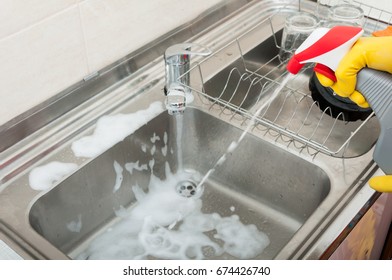 Housekeeping Person Washing And Disinfecting The Sink With Cleaning Spray