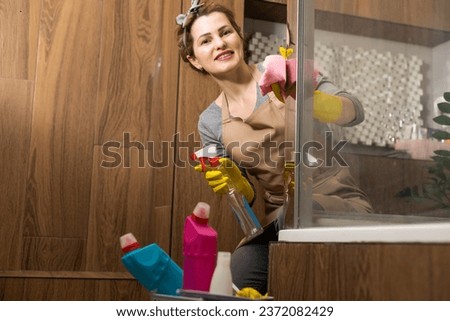 Housemaid cleaning a bathroom, closeup shot