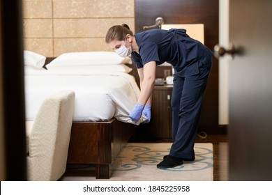 Housemaid In Mask Changing White Mattress Cover