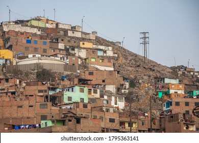 Houses and apartments are built into the hillside and on top of each other in a poor neighborhood in Lima, Peru. - Shutterstock ID 1795363141