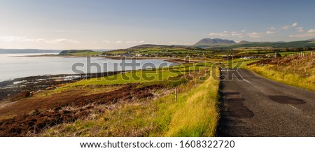 Houses of Blackwaterfoot village cluster on the shore of Drumadoon Bay in the Firth of Clyde on Scotland's Isle of Arran.