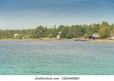 Houses cottages or villas at Pike Bay shores in sunny summer day lake Huron Peninsula, Ontario, Canada. Famous Canadian tourist vacation routs. Cottages for rent and personal leisure. 