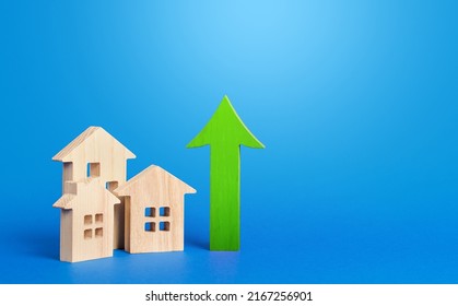Houses and green arrow up. Rising prices and rents. Make money by investing in real estate. Improve housing. High demand. Growth of mortgage rates. Increasing cost of housing concept. - Shutterstock ID 2167256901