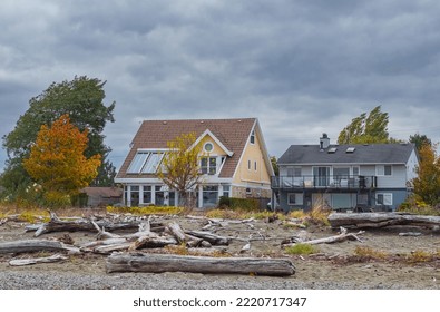 Houses on the beach during Stormy Weather. Coast houses beachfront waterfront in overcast day in Brirish Columbia West Coast Canada. Nobody, street photo, selective focus - Powered by Shutterstock