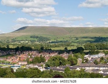 Houses on the edge of Clitheroe, Lancashire with Pendle hill rising beyond.