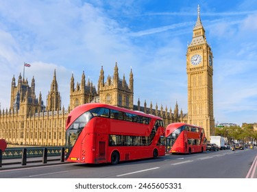 Houses of Parliament with Big Ben and double-decker buses on Westminster bridge, London, UK