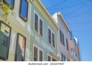 Houses In San Francisco California With Outdoor String Lights On The Roof. Exterior View Of Homes At A Charming Neighborhood With Blue Sky On A Sunny Day.