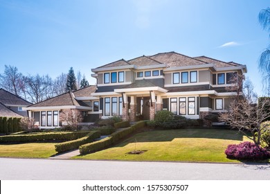 Houses in suburb with Spring Blossom in the north America. Luxury houses with nice white and pink coloured landscape.