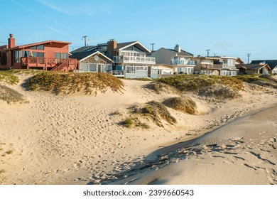 Houses that are set amid coastal sand dunes. Beautiful houses with ocean views in a small beach town somewhere in California - Powered by Shutterstock