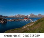 Houses and vessels in a small harbor within the bay of Tasiilaq in Greenland