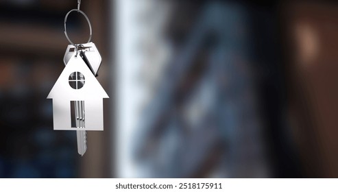 House-shaped keychain image over blurred background. Real estate, new home, charm, keyring, accessory, moving - Powered by Shutterstock