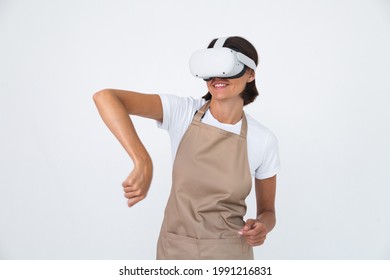 Housewife in apron isolated on white background in vr glasses cooking making dinner play games - Powered by Shutterstock