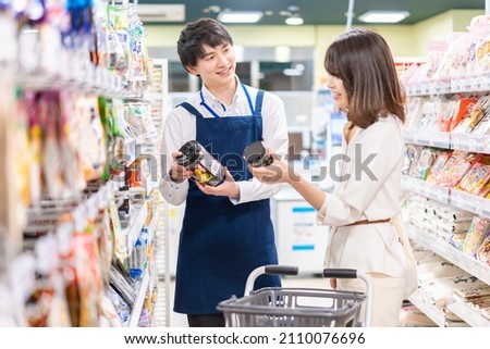 Housewife asking a clerk at a supermarket