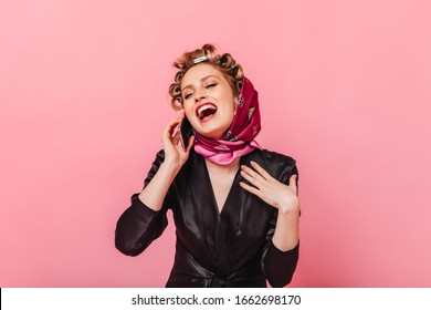 Housewife In Black Dressing Gown Laughs And Talks On Phone On Pink Background