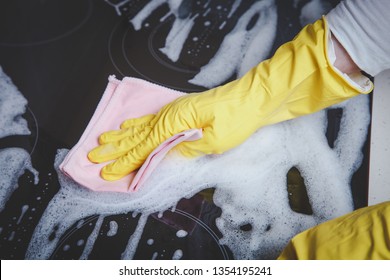 Housewife Cleaning An Induction Plate, Closeup Shot