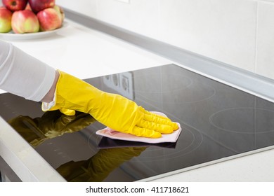 Housewife Cleaning An Induction Plate, Closeup Shot