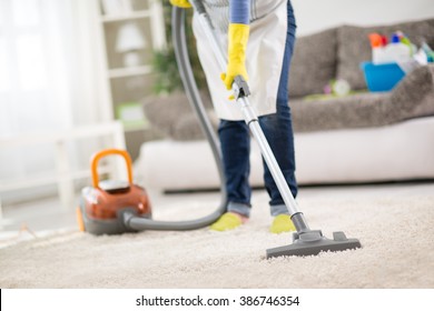 Housewife From Cleaning Service Cleans Carpet With Vacuum Cleaner