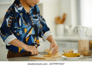 Housewife Cutting Banana For Breakfast
