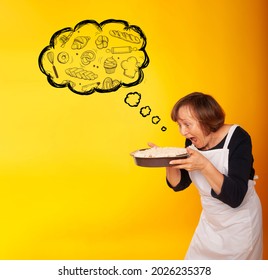 A Housewife With Homemade Cakes On A Colored Background Is Thinking About A Piece Of Pie. Joyful Half-living
Mature Woman Enjoying Birthday Party Eating Apple Pie. Senior Woman Posing With Dessert. 