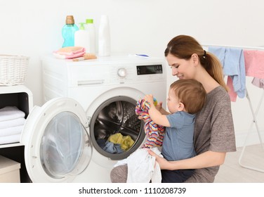 Housewife with little son doing laundry at home - Powered by Shutterstock