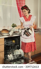 Housewife Loads The Dishes In The Dishwasher. 1950s Style Post Processing Emulation.
