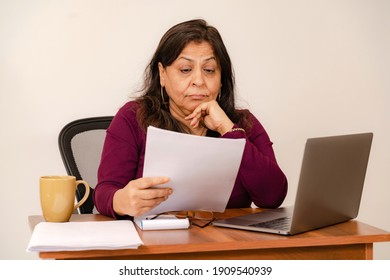 Housewife in stress looking at the bills