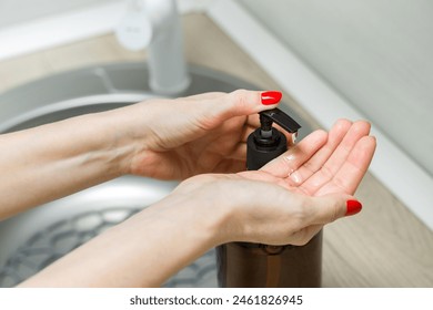 housewife using liquid soap dispenser in the kitchen. bottle of liquid soap. using a soap dispenser.  - Powered by Shutterstock